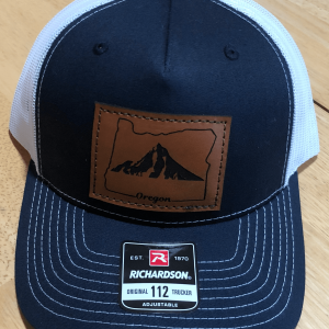 Navy and White Richardson 112 trucker hat with leather patch with image of Mt Hood and word Oregon