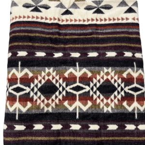 Folded dark brown Western pattern blanket lined with sherpa, with zipper to convert to poncho
