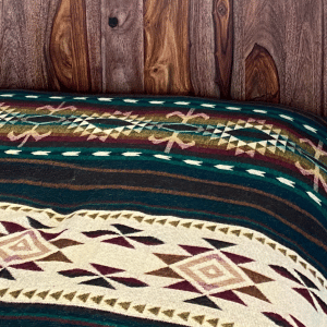 Southwestern design green and brown blanket on bed