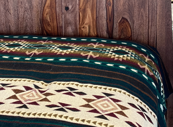 Southwestern design green and brown blanket on bed