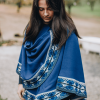 Model wearing blue capelet with shoulder button