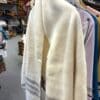Winter White handwoven wool wrap with 3 taupe stripes hanging on hanger