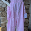 Light pink cotton overalls with drawstring ankles on a mannequin