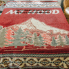 Dark Red Mountain Blanket displayed on bed. Sample has words "Mt Hood" but you can order without the text.