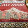 Dark Red Blanket with Mountain image and text "Mt Hood" displayed on bed.