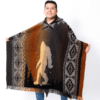 Male model wearing hooded poncho in brown and rust with figure of Bigfoot and geometric border down sides