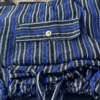 Stack of folded harem pants in royal blue, black and white stripes