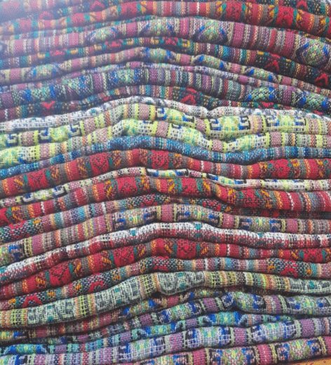 Stack of colorful woven harem pants