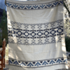 Queen size Native Andean Cross blanket hanging, reverse side cream with blue design