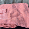 Folded peach cotton harem pants with cargo pocket.