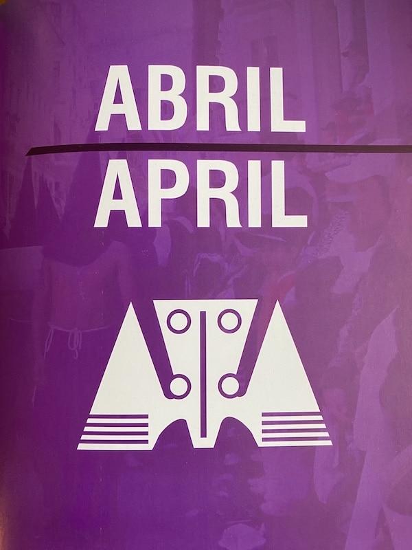 Words Abril April on a purple background with Incan symbol