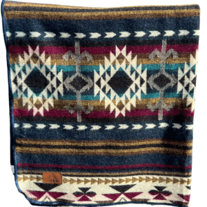 Folded jewel-toned Southwestern pattern throw, against white background.