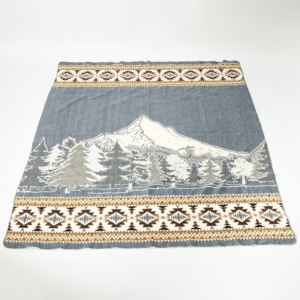 Light gray blanket with image of Mt Hood and evergreens, geometric border in cream and brown across top and bottom edge