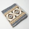 Folded light gray blanket with cream and brown geometric pattern