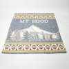 Light gray blanket with words Mt Hood and image of the mountain and evergreen trees