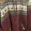 Closeup of adult size burgundy hoodie with alpaca figures on yoke